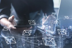 Digital marketing, Email campaign, newsletter, direct sales business strategy concept. Double exposure of business man sending email via smart phone, laptop computer and smart city with e-mail icons