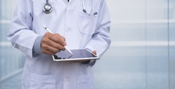 Doctor using electronic pen on  digital tablet, reviewing  medical record writing prescription on digital document in hospital, Electronic medical record system, health and technology, telemedicine