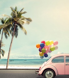 Vintage card of car with colorful balloon on beach blue sky concept of love in summer and wedding honeymoon