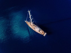 Aerial view to Yacht in deep blue sea. Drone photography