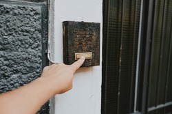 finger ringing a door bell