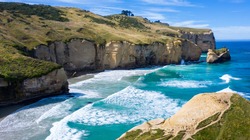 Famous Tunnel beach in New Zealand, DUNEDIN, NEW ZEALAND Popular tourist attraction in Dunedin, South island of New Zealand, amazing coast line from above, Cliff formations at Tunnel Beach