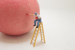 a mini of figure painter painting the apple
