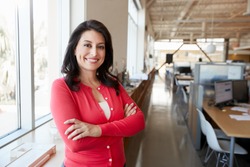 Female Hispanic architect smiling to camera in an office