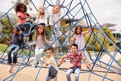 Elementary school kids climbing in the school playground