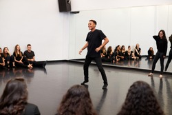 Male Student At Performing Arts School Performs Street Dance For Class And Teacher In Dance Studio