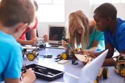 Students In After School Computer Coding Class Building And Learning To Program Robot Vehicle