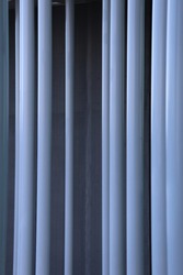 Close up graphic view of supperposed rows of white circular columns. Pattern of white and grey vertical parallel lines. Abstract view of part of a modern building. Architectural geometric view. 