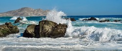 Sea surf at the rocks on the beach. Panorama of sea surf on the beach. Sea surf on the beach. Sea surf panorama