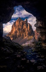 View of the mountain from the cave. Mountain cave hole. Cave in mountain rock. Mountain cave entrance