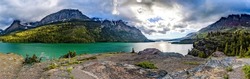 Panoramic landscape of a mountain lake. Mountain lake panorama. Lake in mountains. Mountain lake view