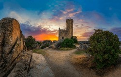 Dawn over a medieval tower. Medieval tower at dawn. Ancient tower of castle ruins. Medieval fortress tower at dawn