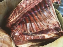 Pork or beef ribs. A large piece of meat on the counter of the store. Fresh pork ribs. Barbecue product