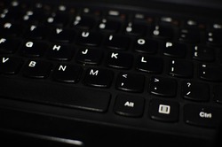 laptop keyboard that is focused on the letter M