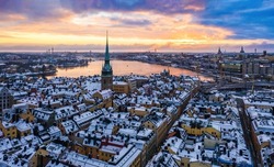 Colorful sunrise over the snowy Gamla stan, Stockholm Sweden