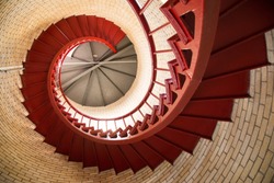 Red iron spiral staircase inside a lighthouse