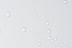 Close up of water drops on gray tone background. Abstarct white wet texture with bubbles on window glass surface or grunge. Raindrop, Realistic pure water droplets condensed for creative banner design