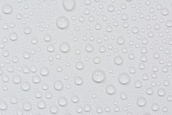 Close up of water drops on black tone background. Abstract gray wet texture with bubbles on plastic PVC surface or grunge. Realistic pure water droplets condensed. Detail of canvas leather texture