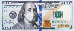 A $ 100 bill in a medical mask. World economy during the COVID-19 pandemic