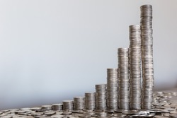 Power of compound interest on your savings illustrated with coins stacks.
