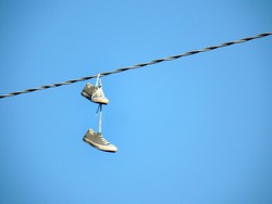 Shoe dangling or shoe flinging, is the practice of throwing shoes whose shoelaces have been tied together so that they hang from overhead wires such as power lines or telephone cables.