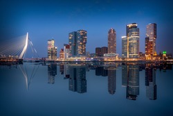 Rotterdam city skyline. Beautiful mirror reflection of the most famous buildings on the river Maas around dusk. 