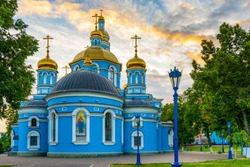 Cathedral of Our Lady's Nativity in summer evening at sunset. Blue stone cathedral church with golden domes against majestic sky. Russian architecture monument, popular landmark. Ufa,Bashkiria, Russia