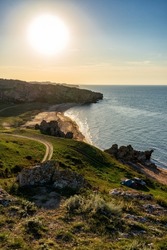 Amazing landscape with sea bay, sand beach and coastal hills and rocks on summer evening at sunset. Trip to seaside. Generalskie Plyazhi or coast of thousand bays. Karalarsky nature park, Crimea