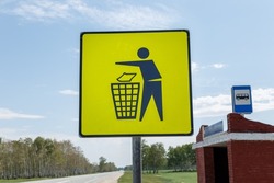 Garbage disposal. Yellow trash can sign at the bus stop. Trash icon sign on yellow label, road signs