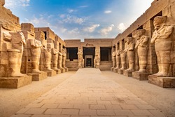 EXPLORING EGYPT - KARNAK TEMPLE - Large pharaoh sculptures inside beautiful Egyptian landmark with hieroglyphics, ancient symbols. Famous world civilization art near Nile River, Cairo and Luxor, Egypt