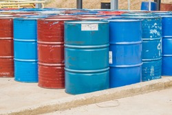 Industry oil barrels or chemical drums stacked up.chemical tank.container of  barrels of hydrocarbons.hazardous waste of black and blue tank oil.At the industrial event is a warehouse of barrels 