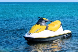 Yellow white water scooter is in the blue sea