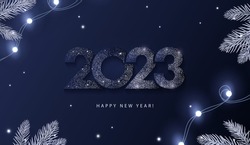 Happy New Year 2023 beautiful sparkling design of numbers on dark blue background with lights, pine branches and shining falling snow. Trendy modern winter banner, poster or greeting card template