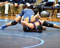 High School wrestlers competing at a wrestling meet.