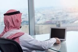 Saudi Arab Man Watching Laptop at Work and Contemplating