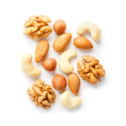 Isolated nuts pattern background. Walnut, cashew, almond and hazelnut on white background. View from above. Macro