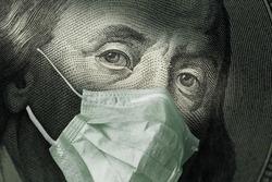 Portrait of Benjamin Franklin 100 dollar Bills with a medical mask from the coronavirus COVID-19.