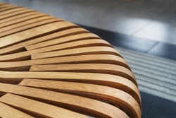 Modern curved wooden bench at the airport. Modern interior close-up
