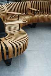 Modern curved wooden bench at the airport. Modern interior