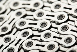 The texture of a bicycle chain is a close-up of the torque transmission links in full screen