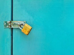 rusty golden lock with locked blue metal door texture background with space