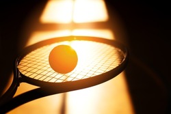 Silhouette of a tennis racket and a ball against the background of the shadow from the window. Active and mobile game. Screen saver.