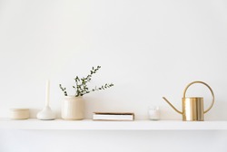 Minimalistic Scandinavian interior. Dishes on white shelves. White details in the interior.