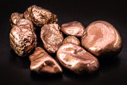 native copper nuggets isolated on black background, ore for industrial use in electrical wires and household utensils