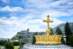 Sanctuary of Lourdes. Dome of The Basilica of Our Lady of the Rosary. The Golden Crown and the Cross. Blue sky with clouds. Hautes-Pyrenees department in the Occitanie region in south-western France