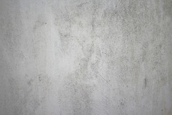Dirty rough surface texture of sand screed cement wall with uneven stains and tiny holes.
