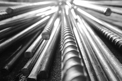 close up steel bar or steel reinforcement bar in the construction site with sunbeam at the morning, steel rods bars can use for reinforce concrete. 