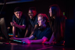 During an esports training session, a team of boys and girls sort out the latest game and smile