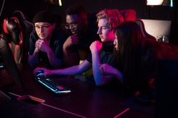 Players of the esports team gathered together in the computer club and watch the stream from the dota 2 world championship