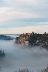 Rocamadour sunrise, Aerial view of the french village and castle on cliff in early morning with fogs in the Canyon of the Alzou